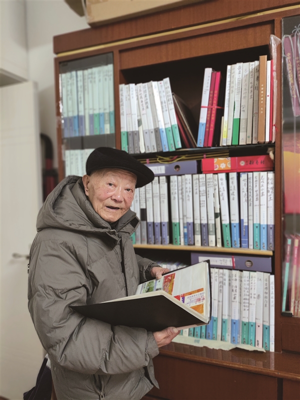屠嘉瑞在书房翻阅自己的收藏.jpg